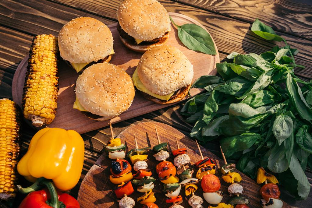 burgers and vegetables cooked outdoors